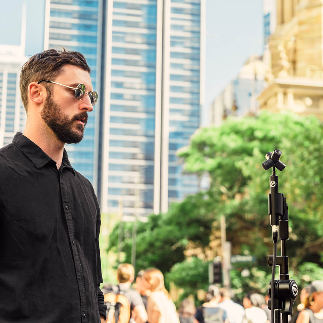 Man standing outdoors with NT-SF1 set up to record pedestrian ambience